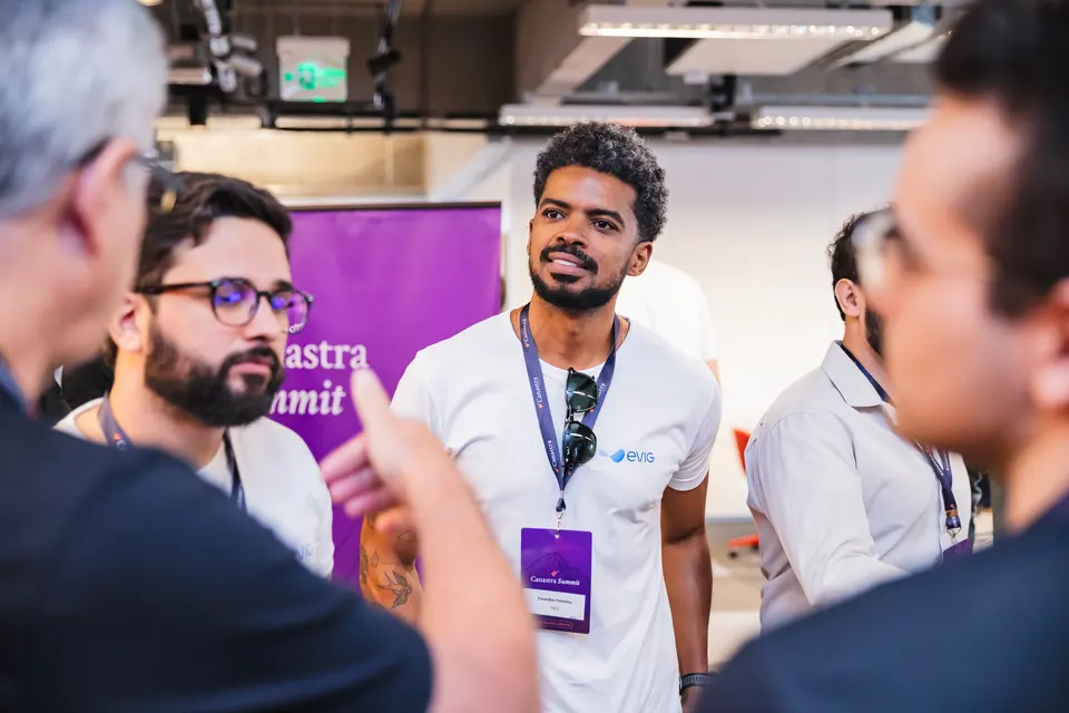 Participants talking in pairs at a Canastra event, with event lanyards