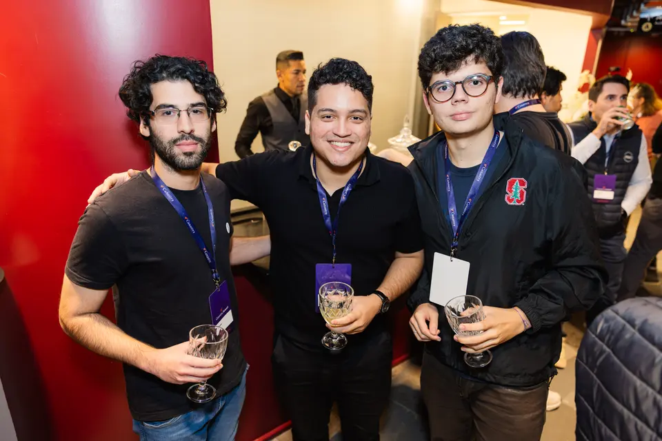 Three participants posing together at the evening gathering