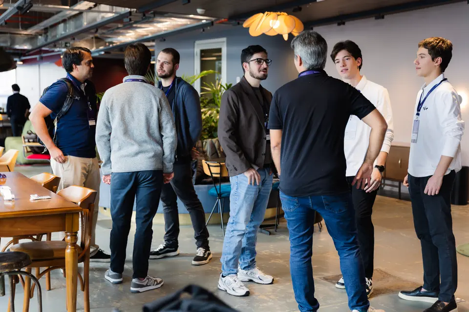 Participants mingling in a room with warm lighting
