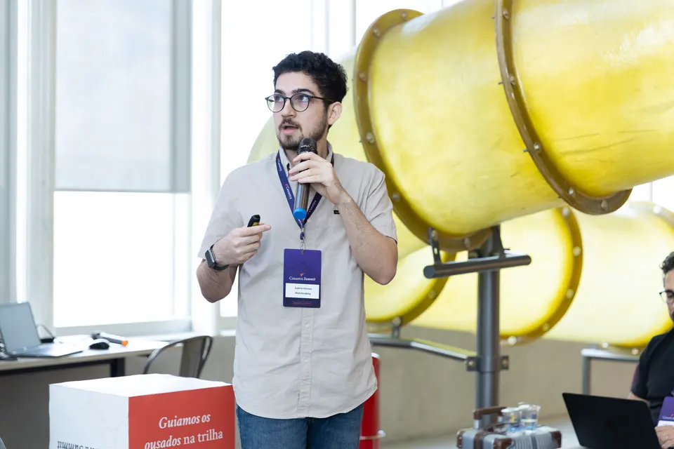 Speaker with a microphone presenting to the cohort