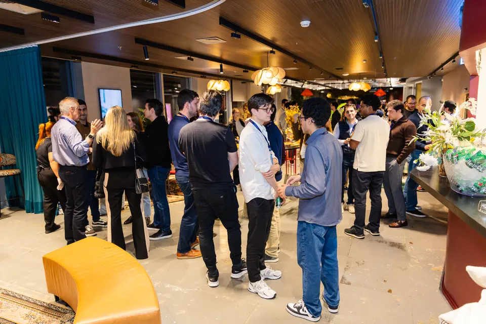 Wide view of participants networking at the evening gathering